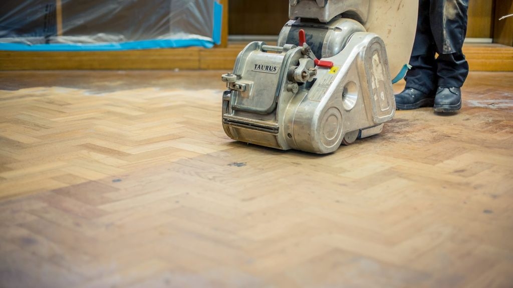 A wooden floor being sanded