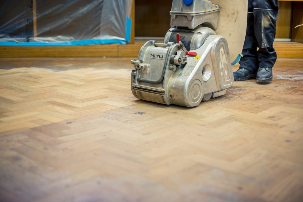 A wooden floor being sanded